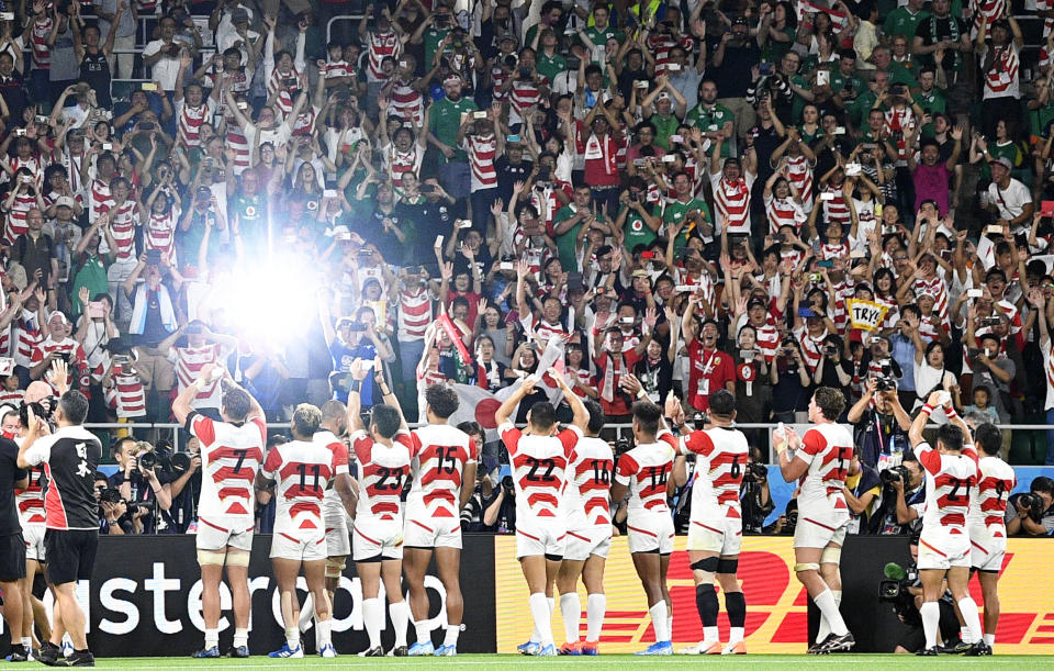 Supporters applaud Japan's players after winning over Ireland during the Rugby World Cup Pool A game at Shizuoka Stadium Ecopa between Japan and Ireland in Shizuoka, Japan, Saturday, Sept. 28, 2019. (Tsuyoshi Ueda/Kyodo News via AP)