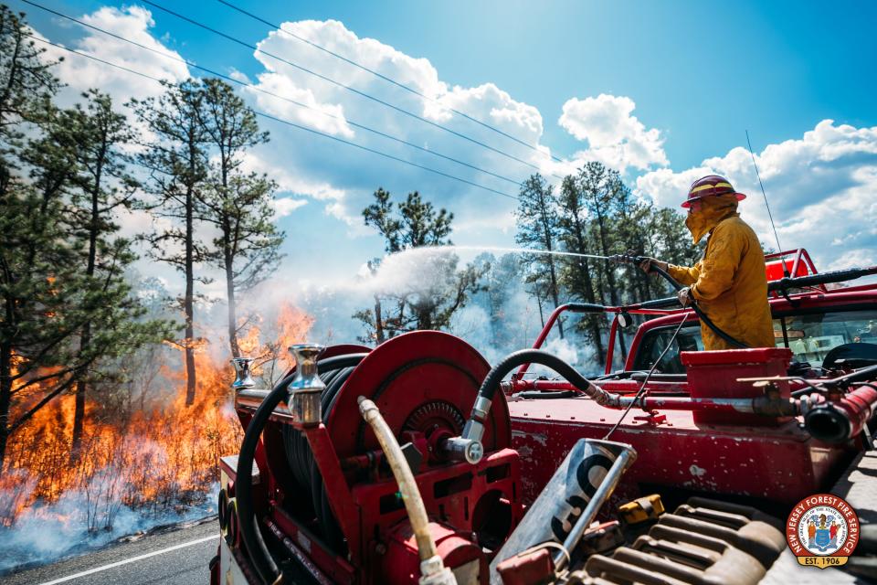 A firefighter with the New Jersey Forest Fire Service works to contain a wildfire in Wharton State Forest on Wednesday, April 24, 2024.