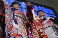 Kimono-clad employees of the Tokyo Stock Exchange and models walk out from the stage during a ceremony marking the start of this year's trading in Tokyo Monday, Jan. 6, 2020, in Tokyo. (AP Photo/Eugene Hoshiko)