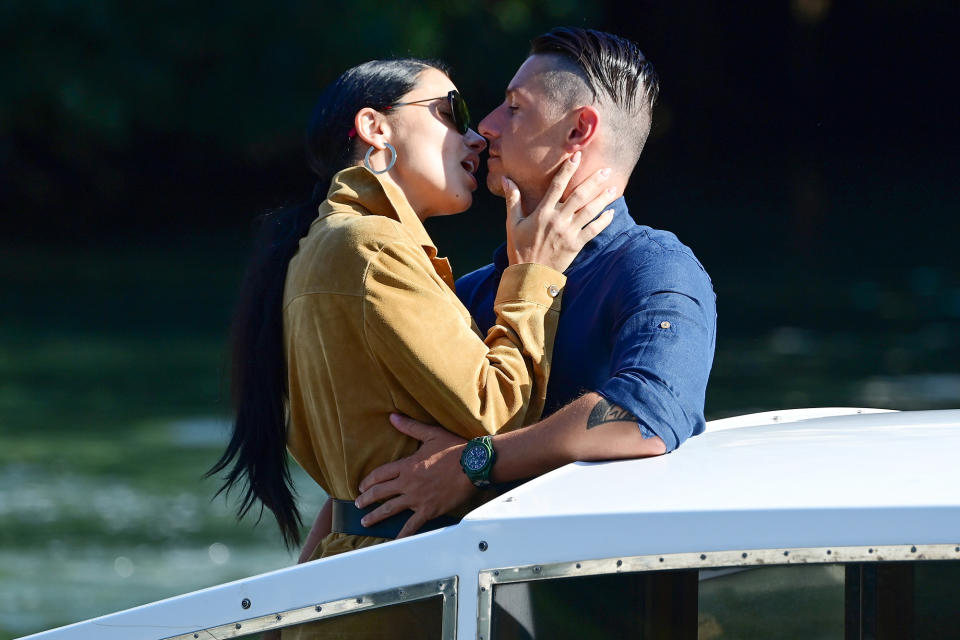 <p>Adriana Lima shared a kiss with her boyfriend, Andre Lemmers, as they arrived on Sept. 2. </p>