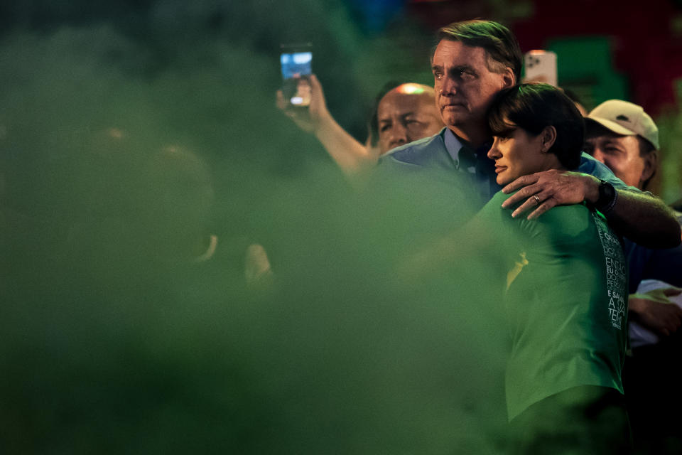 FILE - Brazilian President Jair Bolsonaro embraces his wife, first lady Michelle Bolsonaro, during the annual Christian event March for Jesus, in Rio de Janeiro, Brazil, Aug. 13, 2022. Bolsonaro avoided the spotlight during most of her husband’s presidency. Over the past two months, however, she has stepped forward and become the leading evangelical voice from Bolsonaro’s camp. (AP Photo/Bruna Prado, File)