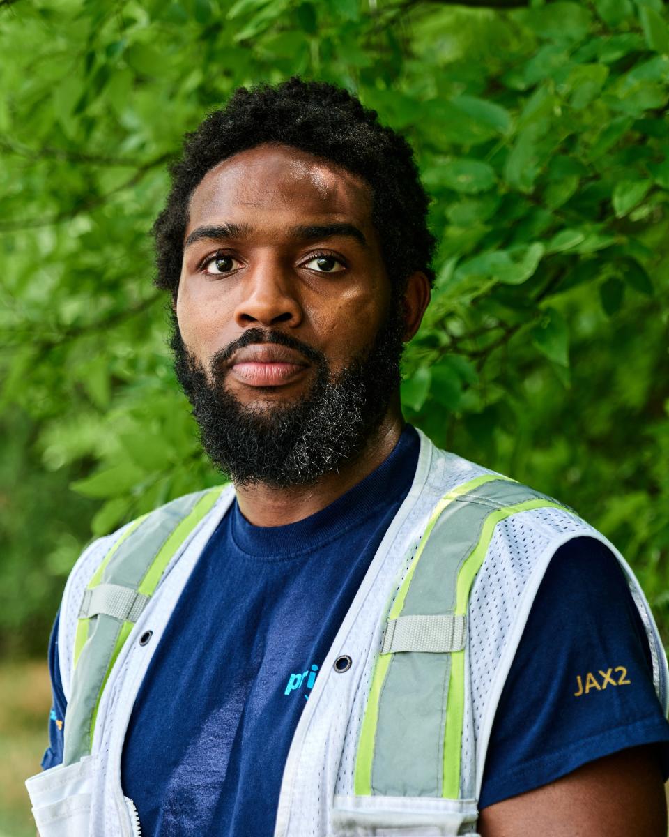 Daniel Olayiwola, wearing his Amazon warehouse uniform.