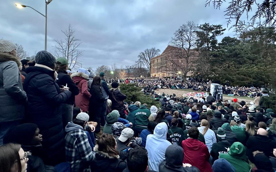 The Michigan State University community gathers at the Rock on campus on Wednesday, Feb. 15, 2023, to honor the lives of three students killed during a shooting rampage on campus on Monday.