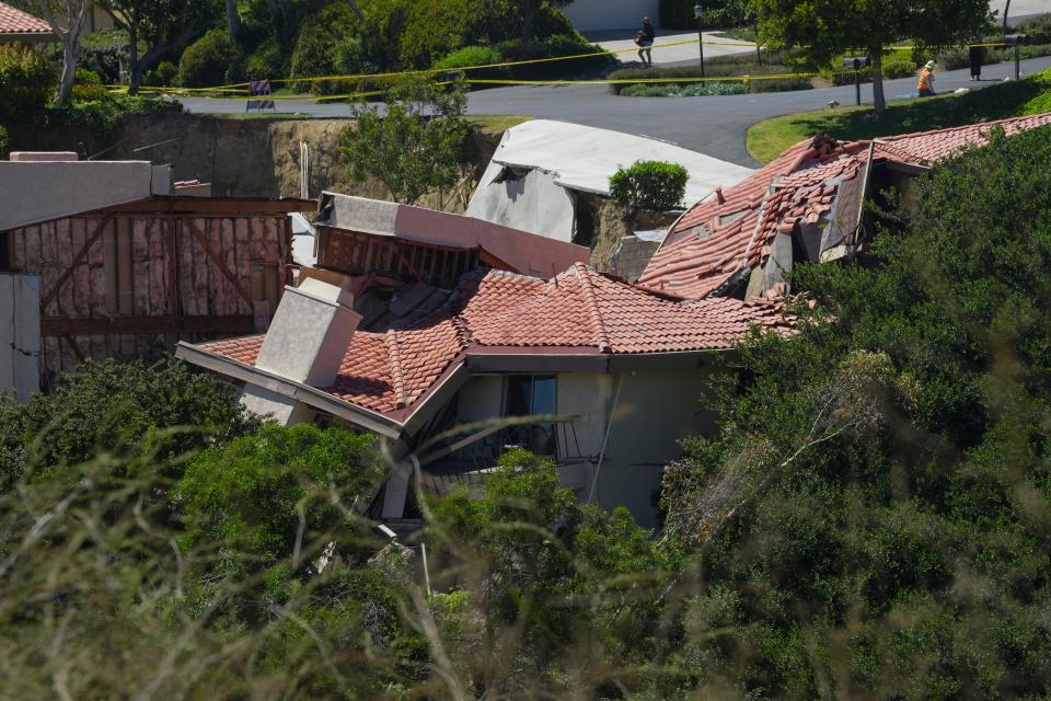 Damaged houses along Peartree Lane in Rolling Hills Estates, California are seen falling into the canyon below on July 11, 2023. Rolling Hills Estates is about 27 miles south of Los Angeles, and a landslide began in the area on Saturday, ripping some homes off their foundations and prompting a dozen other properties that were at risk of falling to be evacuated.