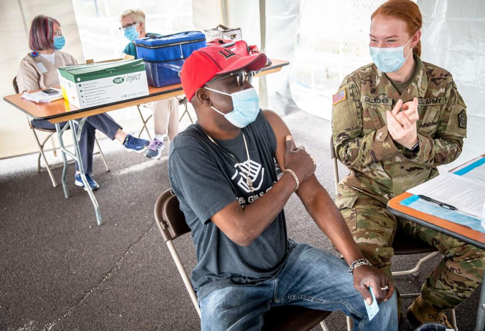 Tony Taylor prepares to receive a dose of the Johnson & Johnson COVID-19 vaccine from Sgt. Reilly Gallagher, of the Illinois Army National Guard, during a vaccine clinic put on by the Sangamon County Department of Public Health and the Illinois National Guard at the SMTD Transfer Station in Springfield, Ill., Tuesday, May 25, 2021. “Just happened to walk by and being nosy and that’s how it happened,” said Taylor why he stopped in to get the vaccine.