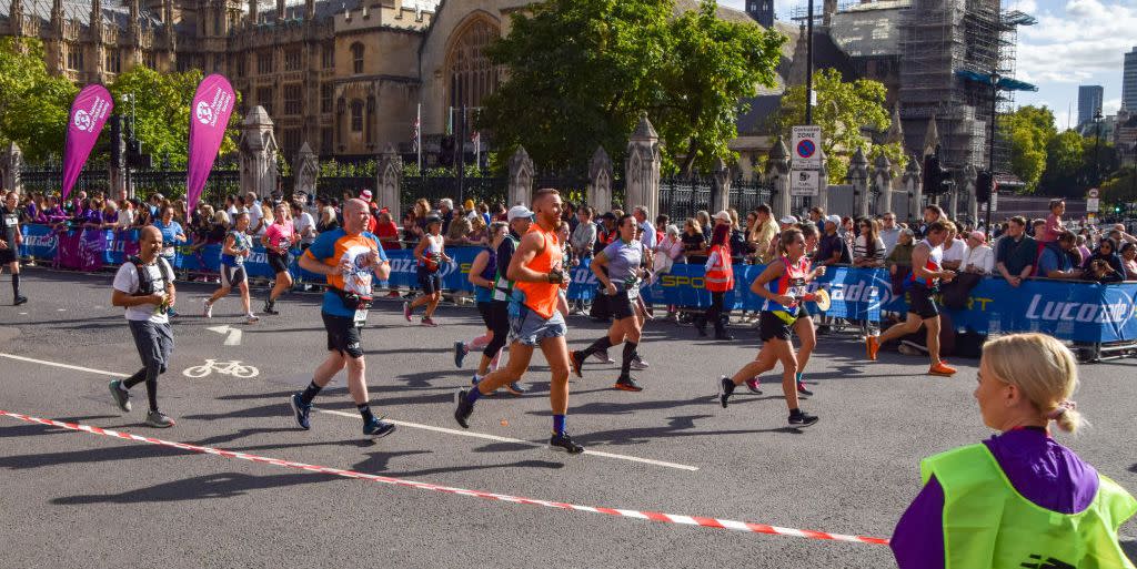 london, united kingdom 20221002 runners pass through parliament square past the houses of parliament during the 2022 london marathon photo by vuk valcicsopa imageslightrocket via getty images