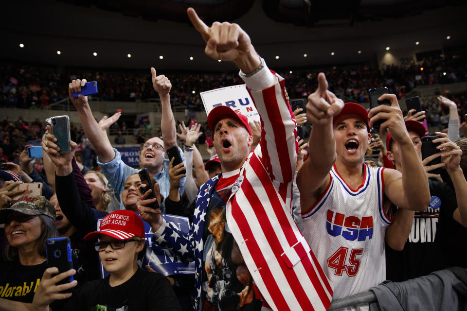 In this Oct. 4, 2018 photo, supporters of President Donald Trump cheer as he arrives for a campaign rally at the Mayo Civic Center in Rochester, Minn. Trump is battling Democrats for control of Congress. But you might think its 2016 all over again. (AP Photo/Evan Vucci)
