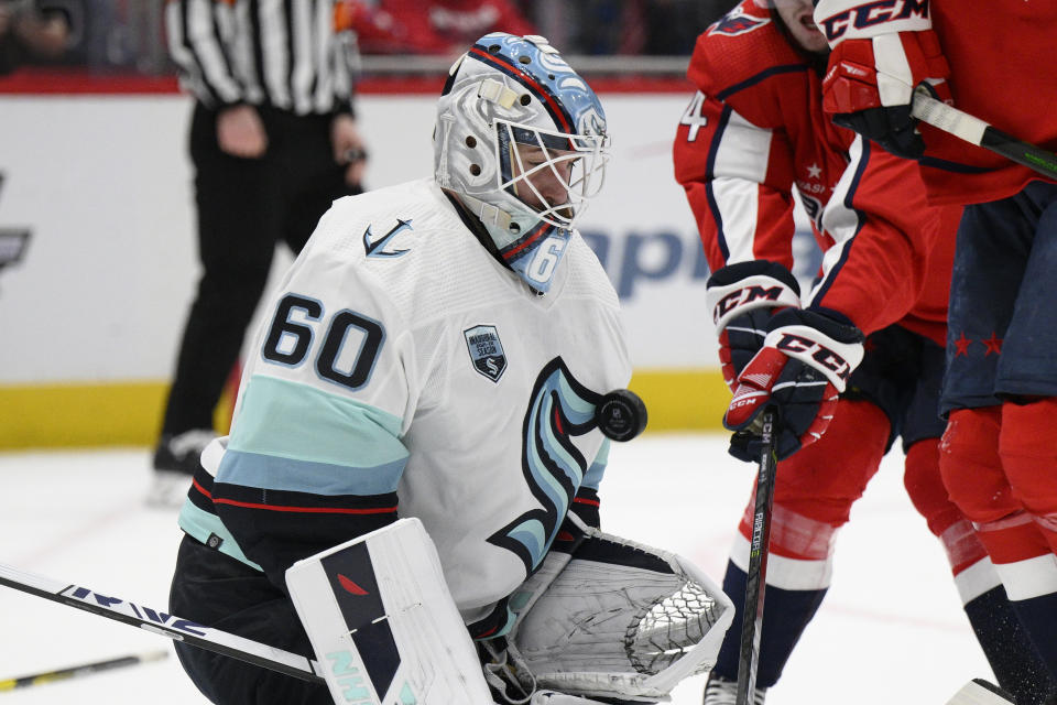 Seattle Kraken goaltender Chris Driedger (60) stops the puck during the first period of an NHL hockey game against the Washington Capitals, Saturday, March 5, 2022, in Washington. (AP Photo/Nick Wass)