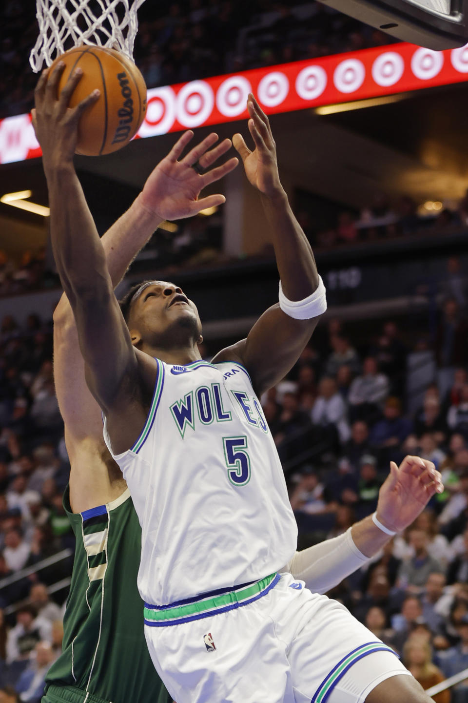 Minnesota Timberwolves guard Anthony Edwards (5) goes to the basket against the Milwaukee Bucks during the second half of an NBA basketball game Friday, Feb. 23, 2024, in Minneapolis. (AP Photo/Bruce Kluckhohn)