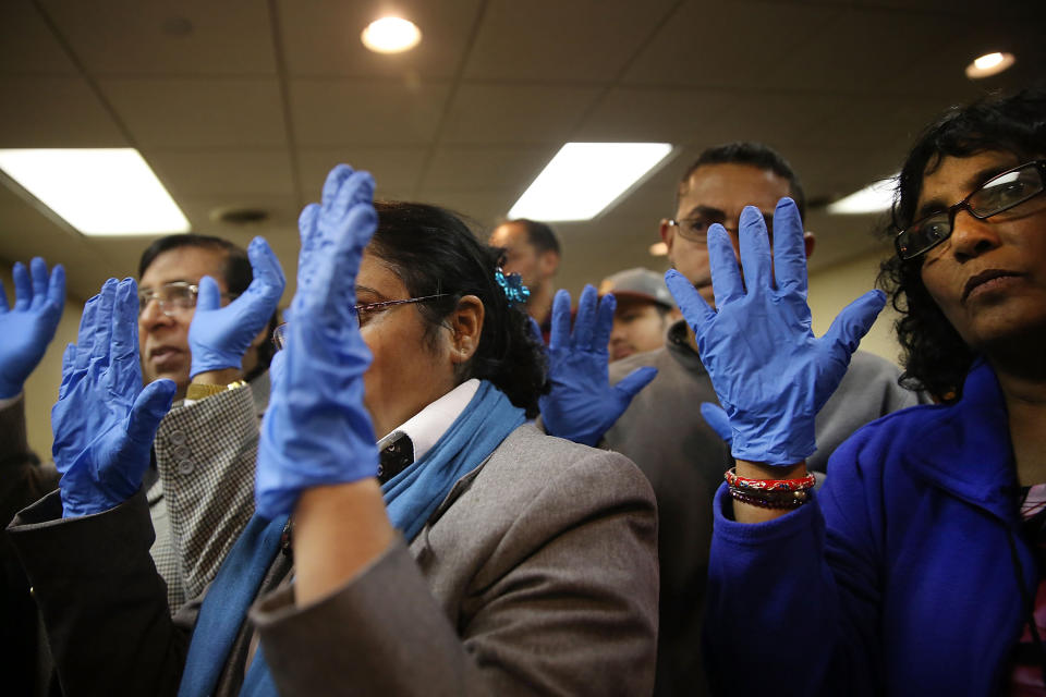 Workers with the union 32BJ, many of them airline cabin cleaners, terminal cleaners and wheelchair attendants, participate in a class on how to better protect themselves from infectious diseases in the wake of increased concerns around the Ebola virus on October 9, 2014 in New York City.