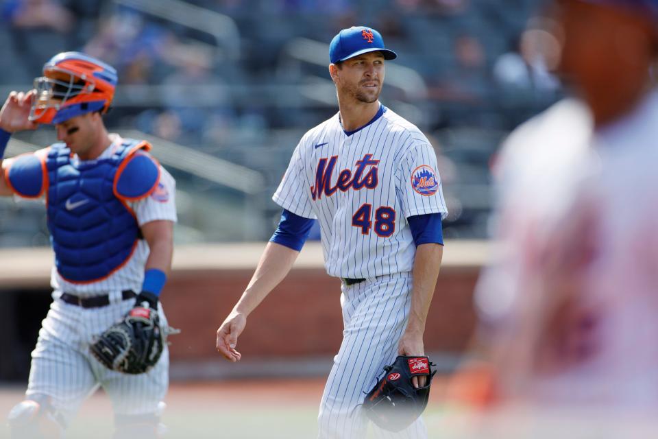 Jacob deGrom walks off the mound in the eighth inning.