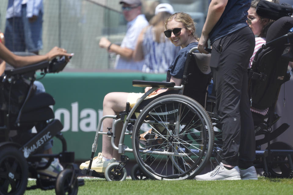 Sarah Langs, an MLB sports writer, smiles as she is honored before the game between the New York Yankees and the Cincinnati Reds, Thursday, July 4, 2024, in New York. (AP Photo/Pamela Smith)