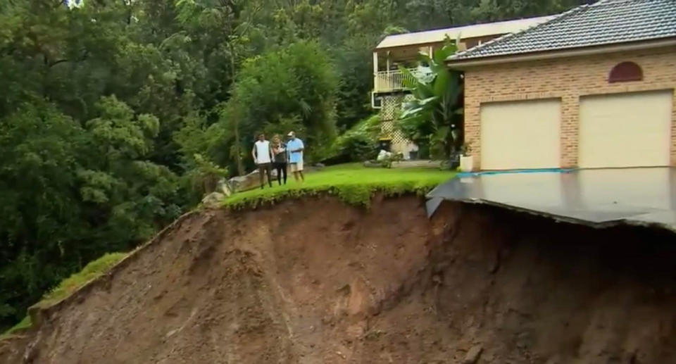 The Buksh family looking at the landslide in Emu Heights.  