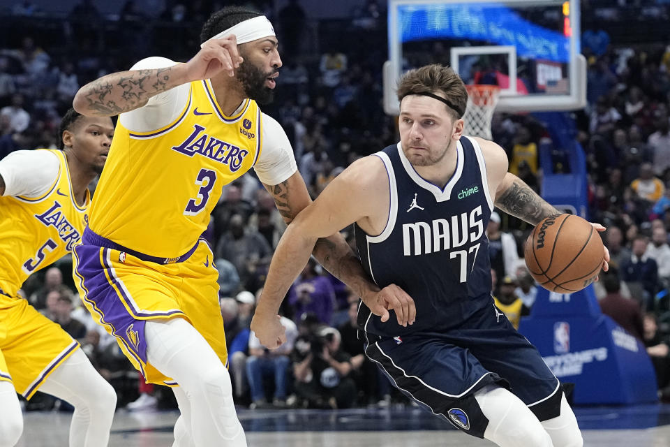 Dallas Mavericks guard Luka Doncic drives against Los Angeles Lakers forward Anthony Davis (3) during the first half of an NBA basketball game in Dallas, Tuesday, Dec. 12, 2023. (AP Photo/LM Otero)