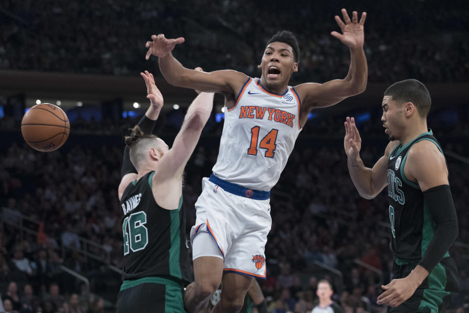 New York Knicks guard Allonzo Trier (14) is fouled as the drives to the basket against Boston Celtics forward Aron Baynes (46) and Boston Celtics forward Jayson Tatum (0) during the first half of an NBA basketball game, Saturday, Oct. 20, 2018, at Madison Square Garden in New York. (AP Photo/Mary Altaffer)