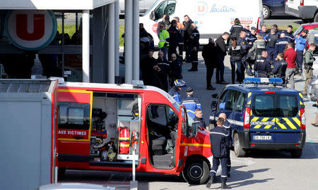 A general view shows gendarmes and police officers at a supermarket after a hostage situation in Trebes, France, March 23, 2018. REUTERS/Regis Duvignau