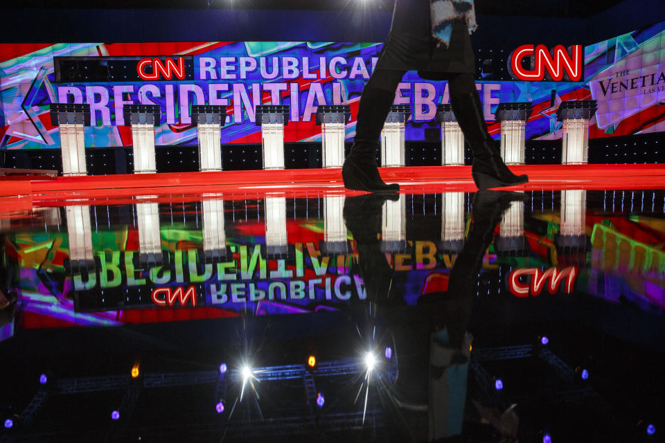 A member of the media walks past podiums on stage ahead of the Republican presidential candidate debate in Las Vegas, Nevada.