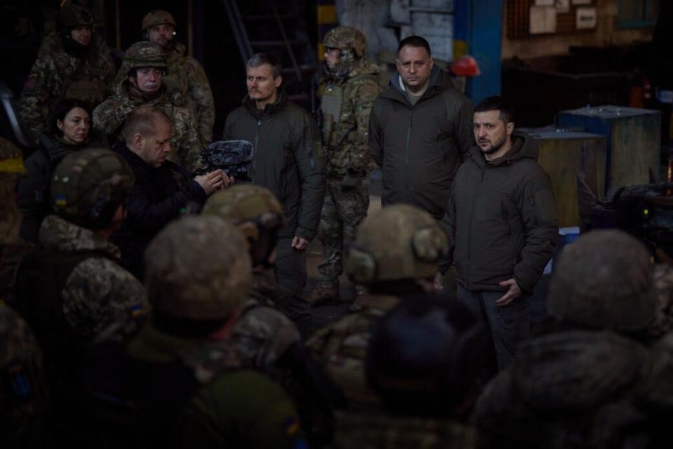 Ukrainian President Volodymyr Zelenskyy (R) meets with the Ukrainian servicemen who are defending the city of Bakhmut within his working trip in Bakhmut, Ukraine on December 20, 2022