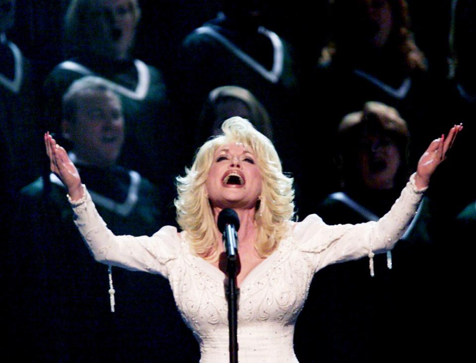 Dolly Parton sings her "Hello, God" with a full choir during the 36th annual CMA Awards show at the Grand Ole Opry House Nov 6, 2002. In March, Parton released the thriller "Run, Rose, Run" with James Patterson.