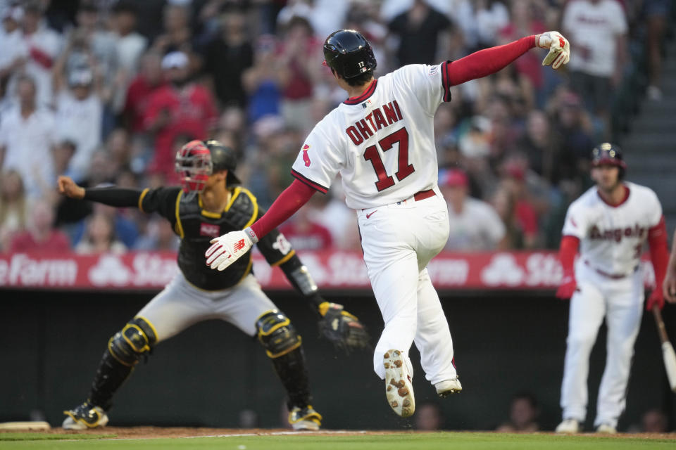 Los Angeles Angels starting pitcher Shohei Ohtani (17) scores off of a double hit by Mickey Moniak during the fourth inning of a baseball game against the Pittsburgh Pirates in Anaheim, Calif., Friday, July 21, 2023. (AP Photo/Ashley Landis)