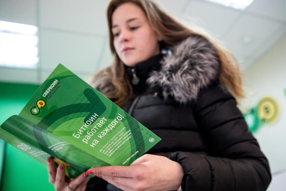 Bitcoin crashed 10% to $34,046 on Thursday, its lowest level in a month. Above, a customer looking through an information leaflet at Sbercoin, Russia's first cryptocurrency exchange office in Moscow. Photo: Sergei Bobylev/TASS via Getty