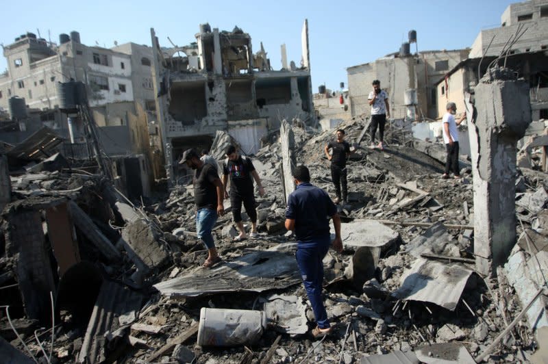 People look for salvageable belongings after an Israeli airstrike in Rafah in the southern Gaza Strip on Wednesday. Photo by Ismael Mohamad/UPI