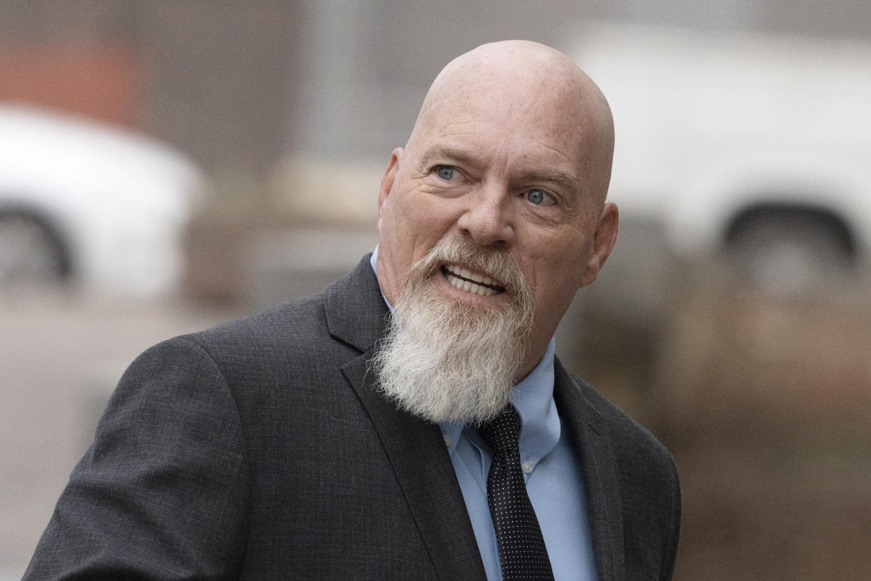 Richard Barnett, left, an Arkansas man who was photographed with his feet on a desk in former House Speaker Nancy Pelosi's office during the Jan. 6 U.S. Capitol riot, arrives at federal court in Washington, Tuesday, Jan. 10, 2023. (AP Photo/Manuel Balce Ceneta)