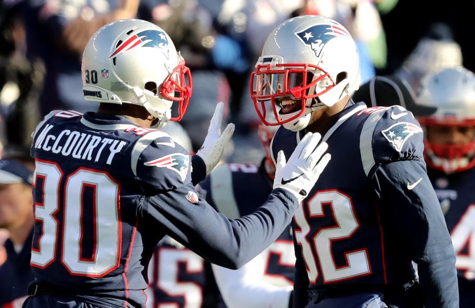 Jason McCourty, left, and Devin McCourty react during the second quarter in the AFC Divisional playoff game against the Los Angeles Chargers at Gillette Stadium in 2019.