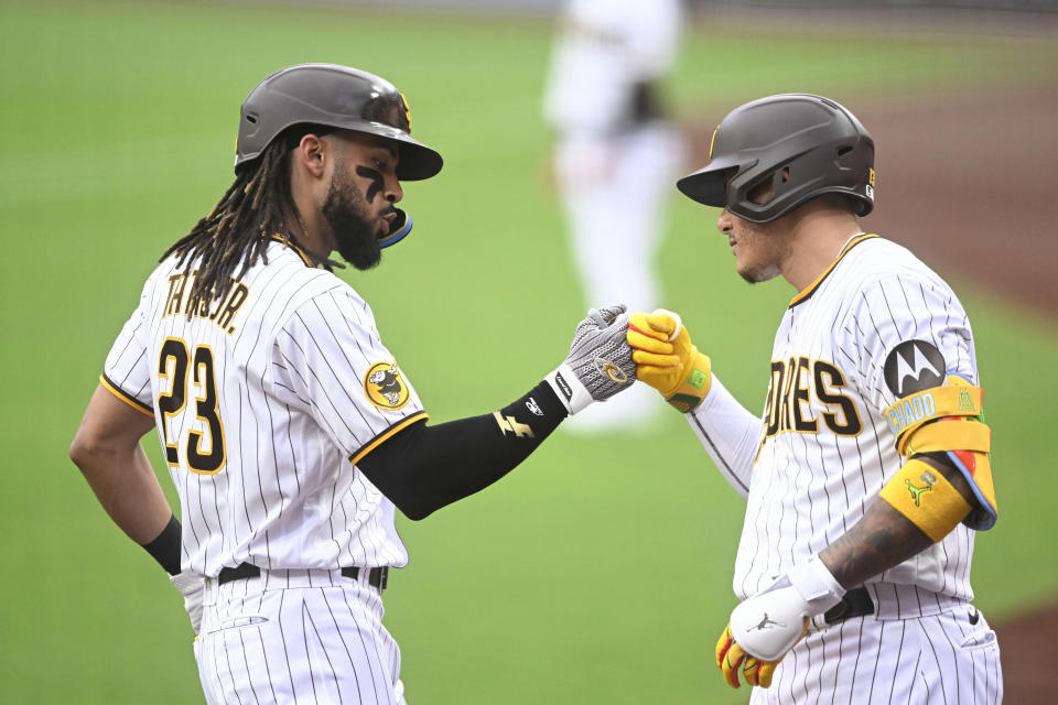 San Diego Padres' Fernando Tatis Jr., left, is congratulated by Manny Machado after hitting a solo home run against the Cleveland Guardians during the first inning of a baseball game Wednesday, June 14, 2023, in San Diego. (AP Photo/Denis Poroy)