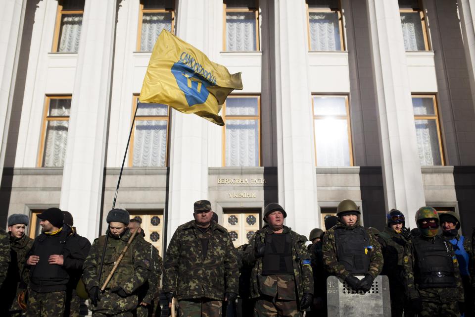 Self defense volunteers line up outside the Parliament in Kiev, Ukraine, Monday, March 17, 2014. A referendum held in Crimea on Sunday was widely condemned by Western leaders who were planning to discuss economic sanctions to punish Russia on Monday. Ukraine's new government in Kiev called the referendum a "circus" directed at gunpoint by Moscow.(AP Photo/David Azia)