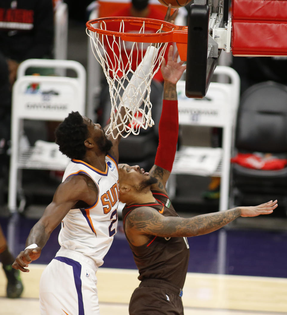 Phoenix Suns' Deandre Ayton blocks the shot of Portland Trail Blazers Damian Lillard during the first half of an NBA basketball game Monday, Feb. 22, 2021, in Phoenix. (AP Photo/Darryl Webb)