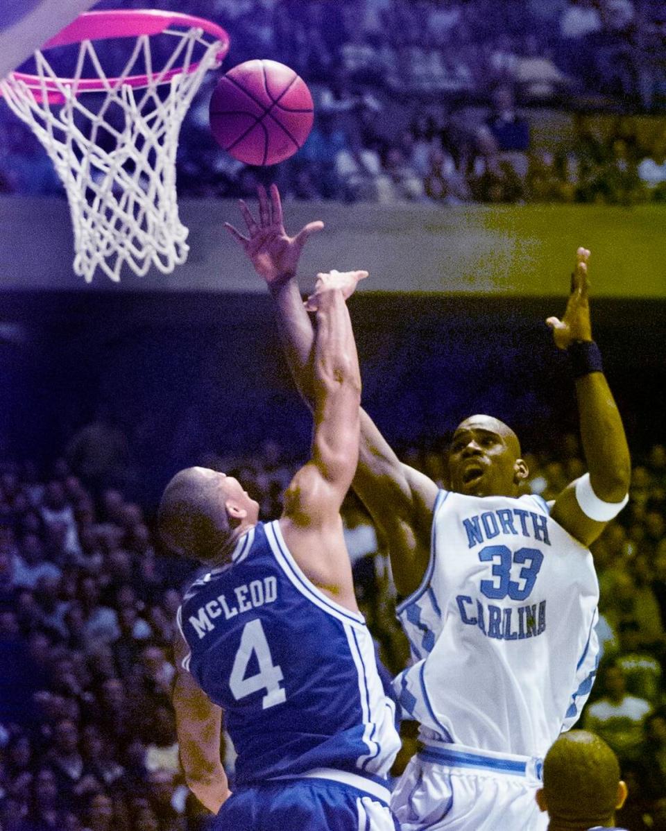 UNC’s Antawn Jamison drives to the basket against Duke’s Roshown Mcleod in Chapel Hill Feb. 5, 1998.