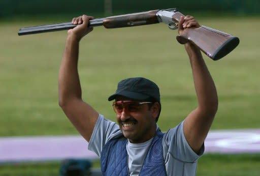 Kuwait's Fehaid al-Deehani winner of the bronze medal, in the men's trap final at the London 2012 Olympic Games, celebrates at The Royal Artillery Barracks in London on August 6, 2012. AFP PHOTO/MARWAN NAAMANI