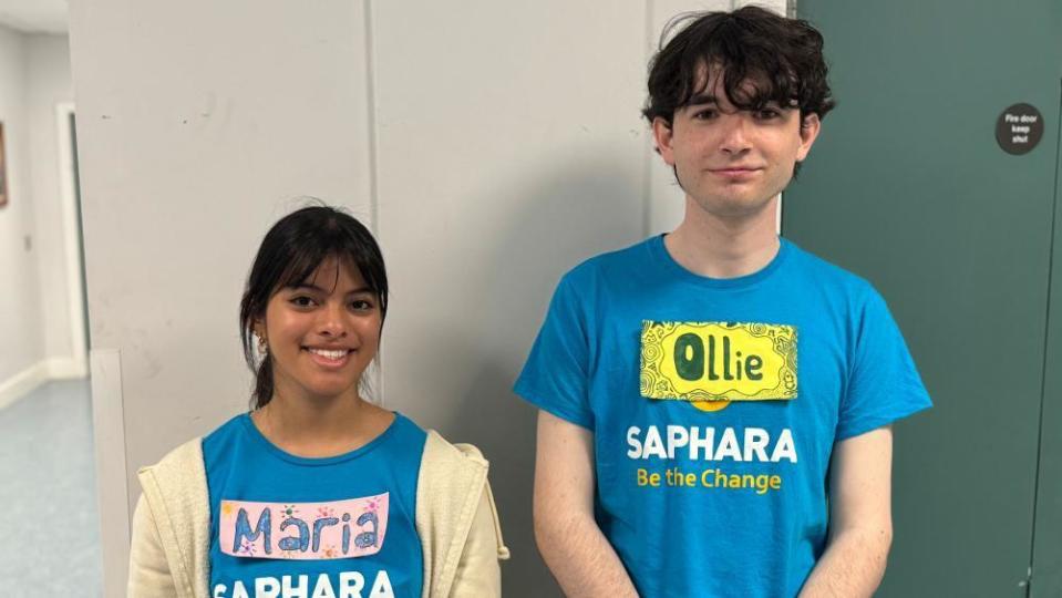 A girl and boy wearing light blue tshirts and name tags