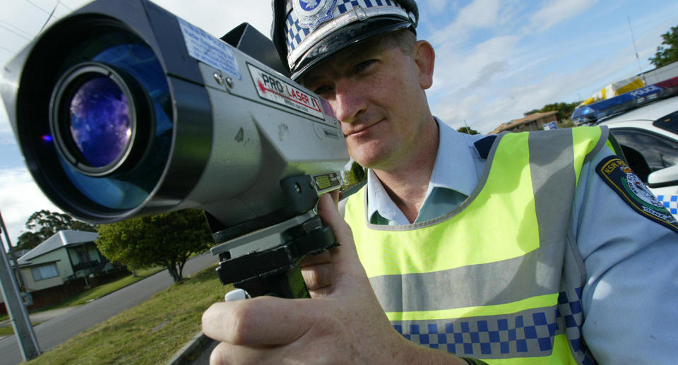 Tuggerah Lakes highway patrol supervisor Gary Carr stands with a speed camera.