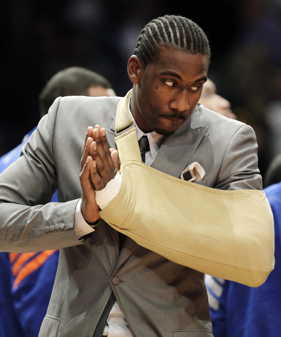 FILE - New York Knicks forward Amare Stoudemire watches from the baseline with his arm in a sling before Game 3 of an NBA basketball first-round playoff series at Madison Square Garden in New York, Thursday, May 3, 2012. Stoudemire sat the game out after a surgeon repaired a muscle in his hand Tuesday after he cut it punching through the glass of a fire extinguisher case following Game 2. The Heat defeated the Knicks 96-81. The Miami Heat and New York Knicks will start the sixth edition of their playoff rivalry on Sunday, April 30, 2023, when the Eastern Conference semifinals start at Madison Square Garden. (AP Photo/Kathy Willens, File)