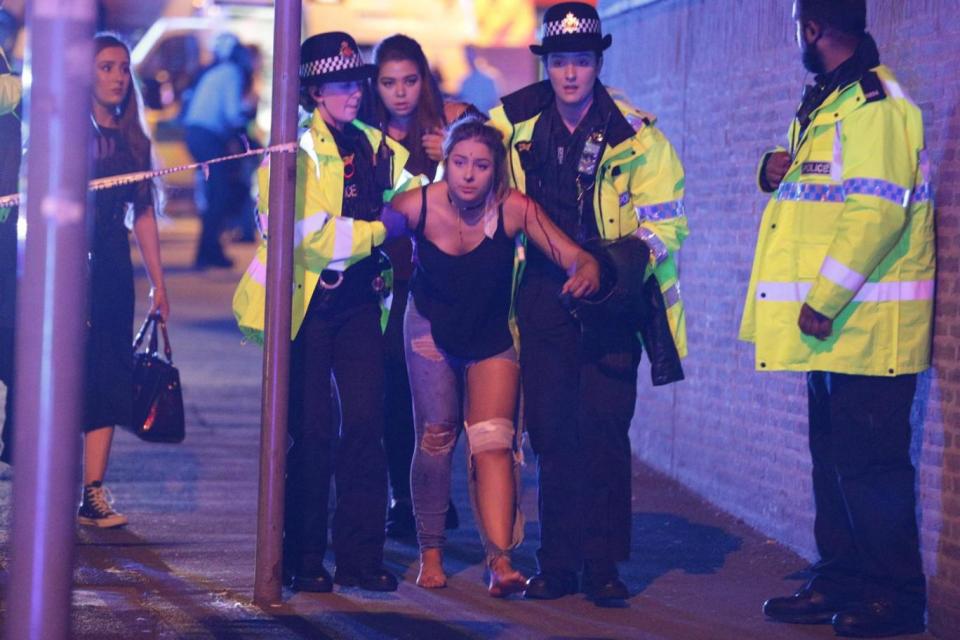 Explosion: Injured concertgoers were helped by armed police outside Manchester Arena (Joel Goodman/LNP)