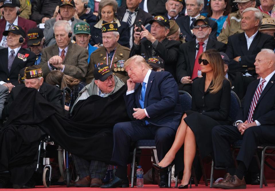 U.S. President Donald Trump chats with an American veteran of The Battle of Normandy as First Lady Melania Trump looks on at the main ceremony to mark the 75th anniversary of the World War II Allied D-Day invasion of Normandy as American Battle of Normandy veterans and family members look on at Normandy American Cemetery on June 06, 2019 near Colleville-Sur-Mer, France. Veterans, families, visitors, political leaders and military personnel are gathering in Normandy to commemorate D-Day, which heralded the Allied advance towards Germany and victory about 11 months later.