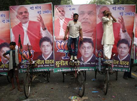 A supporter (R) blows a conch shell during celebrations before India's Hindu nationalist Narendra Modi was crowned as the prime ministerial candidate for India's main opposition Bharatiya Janata Party (BJP) outside the party headquarters in New Delhi September 13, 2013. REUTERS/Ahmad Masood