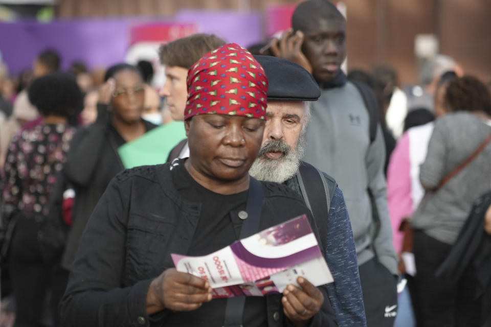 People queue for information or to apply for a job Tuesday, Sept. 26, 2023 in Saint-Denis, a northern suburb of Paris. Paris Olympics organizers and their partners organized a giant job fair meant to help filling about 16,000 vacancies in key sectors including catering, security, transport and cleaning. About 50 companies are recruiting to be able to welcome next year millions of spectators and 14,500 athletes. (AP Photo/Nicolas Garriga)