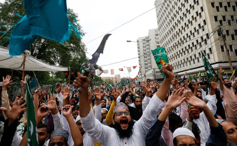 FILE PHOTO: People chant slogans against the satirical French weekly newspaper Charlie Hebdo, which reprinted a cartoon of the Prophet Mohammad, during a protest in Karachi