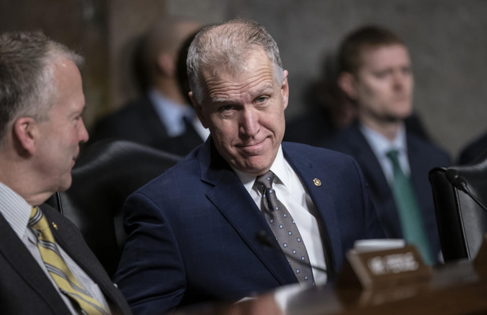 Sen. Thom Tillis, R-N.C., joined at left by Sen. Dan Sullivan, R-Alaska, attends a Senate Armed Services hearing on Capitol Hill in Washington, prior to the vote on President Donald Trump's national emergency at the border, Thursday, March 14, 2019. Changing his vote from the public stance he took last month, Tillis voted to support President Donald Trump's declaration of a national emergency to pay for his border wall. (AP Photo/J. Scott Applewhite)