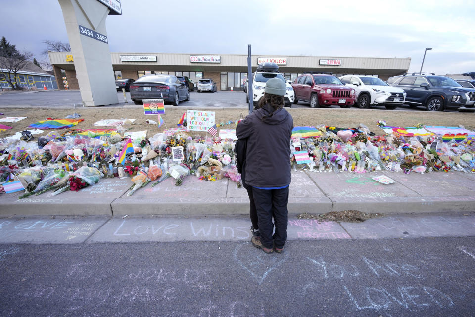 A couple hug at a makeshift memorial Wednesday, Nov. 23, 2022, in Colorado Springs, Colo., for the victims of a mass shooting last weekend at Club Q, a gay nightclub. (AP Photo/David Zalubowski)