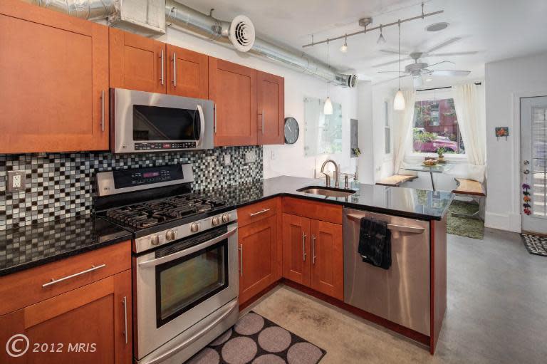 The kitchen introduces a black, white and steely gray palette that recurs throughout the house. Next photo: The second level.