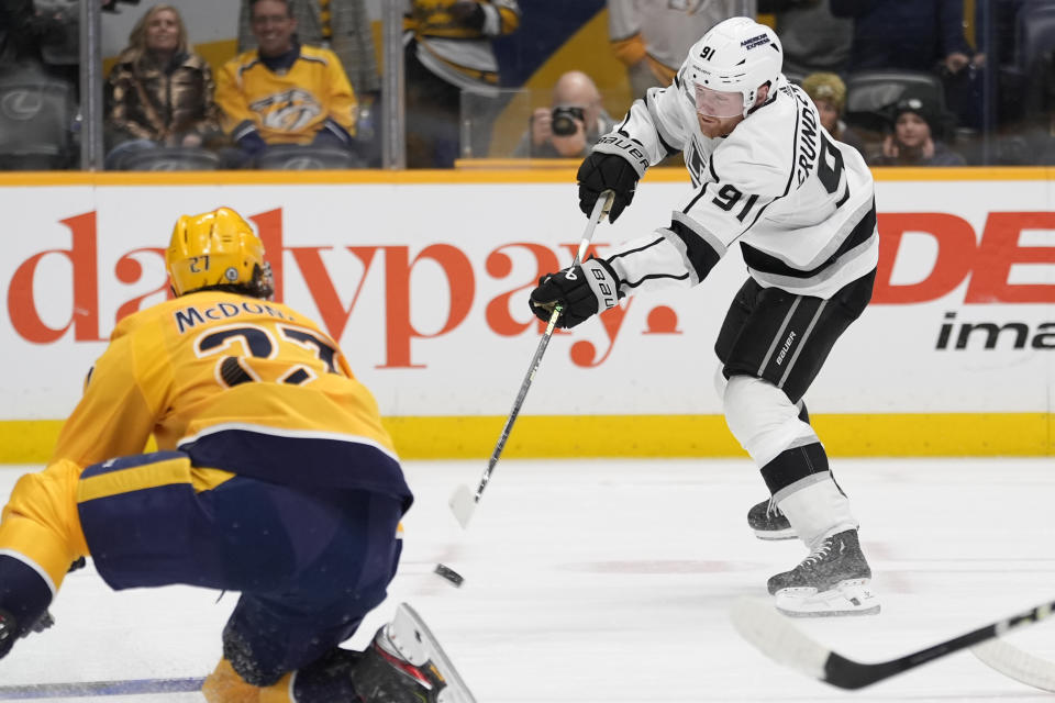 Los Angeles Kings right wing Carl Grundstrom (91) shoots the puck to score a goal past Nashville Predators defenseman Ryan McDonagh (27) during the first period of an NHL hockey game Wednesday, Jan. 31, 2024, in Nashville, Tenn. (AP Photo/George Walker IV)