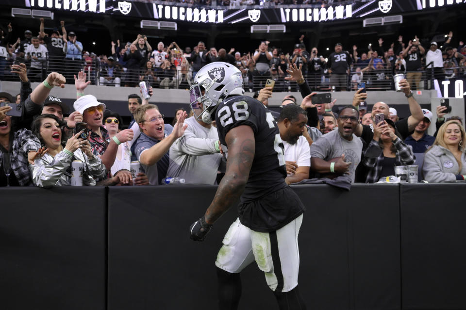 Las Vegas Raiders running back Josh Jacobs reacts with fans after a touchdown during the second half of an NFL football game against the Houston Texans Sunday, Oct. 23, 2022, in Las Vegas. (AP Photo/David Becker)