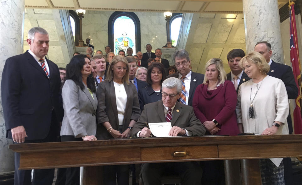 Mississippi Gov. Phil Bryant is surrounded by lawmakers at the Capitol in Jackson, Miss., on Thursday, March 21, 2019, as he signs a bill that would ban most abortions once a fetal heartbeat can be detected. (Photo: Emily Wagster Pettus/AP)