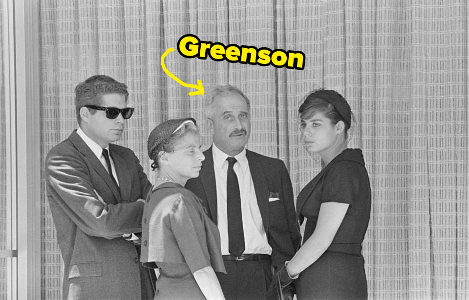 arrow pointing to greenson standing with a group of people