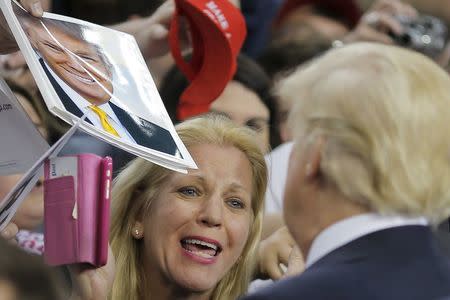 Republican U.S. presidential candidate Donald Trump talks with a supporter during a campaign event in Harrisburg, Pennsylvania, U.S., April 21, 2016. REUTERS/Carlos Barria