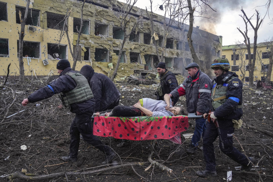 FILE - A pregnant woman whose pelvis had been crushed and her hip detached during Russian shelling is evacuated from a maternity in Mariupol, Ukraine, March 9, 2022. The woman was taken to another hospital closer to the front line but did not survive. (AP Photo/Evgeniy Maloletka, File)